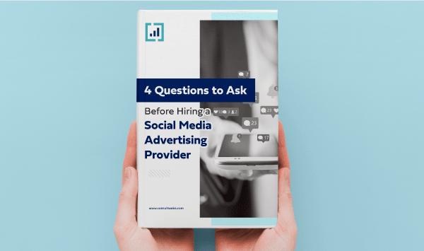 Person holding a guide titled Essential Questions for Choosing a Social Media Ad Agency.