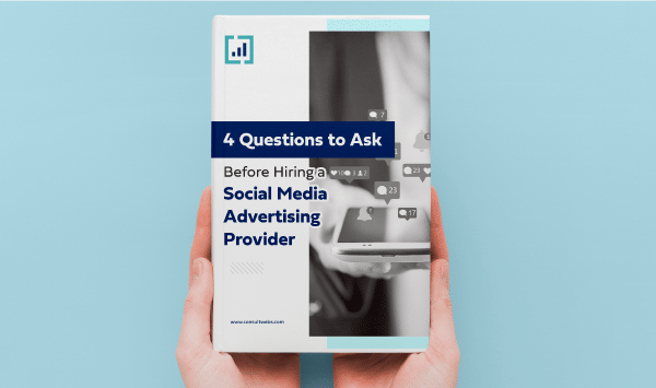 Person holding a guide titled essential questions for choosing a social media ad agency.