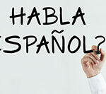 Hand writes habla español? On whiteboard, questioning spanish language proficiency.