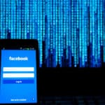 Smartphone with facebook login screen, set against a blurred backdrop of blue digital data.