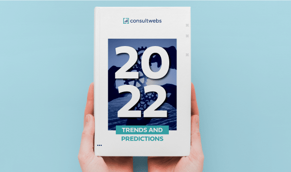 Hands holding 2022 Industry Forecast and Insights report against a light blue background.