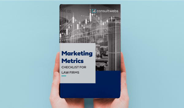 Hands holding Essential Marketing Metrics Guide for Law Firms by consultwebs against a blue background.